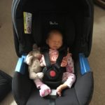 Baby Isla asleep in Silver Cross car seat.