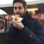 Nicholas Moon eating a hot dog at Baejarins Beztu Pylsur in Reykjavik.