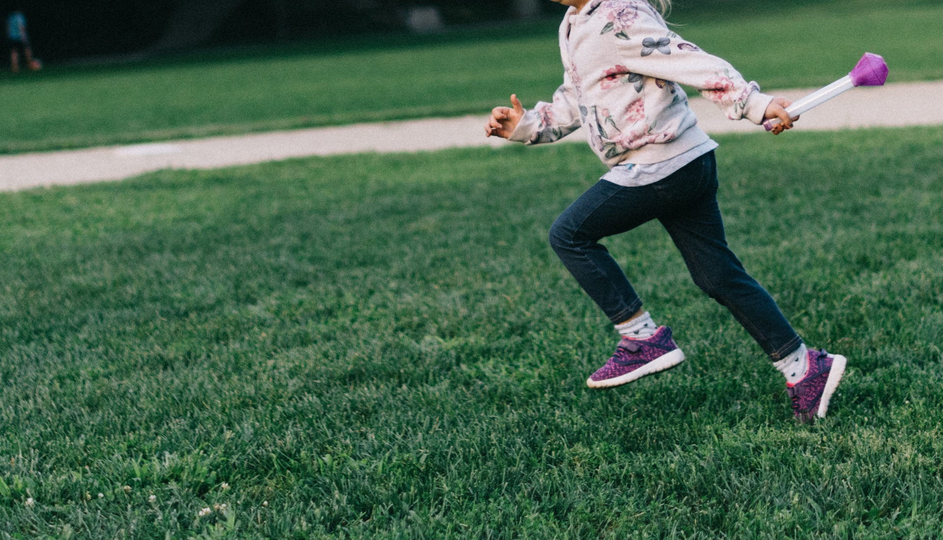 Child running across graa