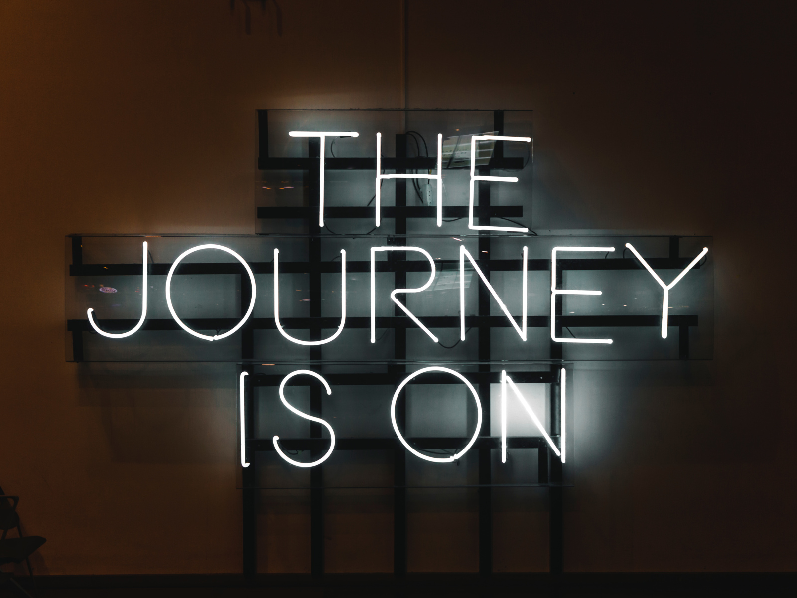 Neon lights spelling 'The Journey Is On'