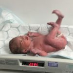 Newborn baby Isla on scales weighing 2.695kg.
